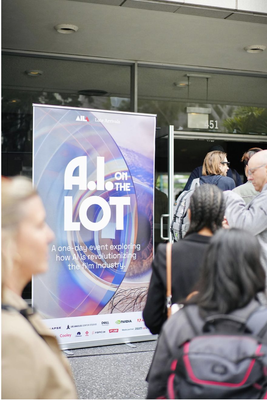 Attendees gather at the doors beside a tall AI on the Lot banner.