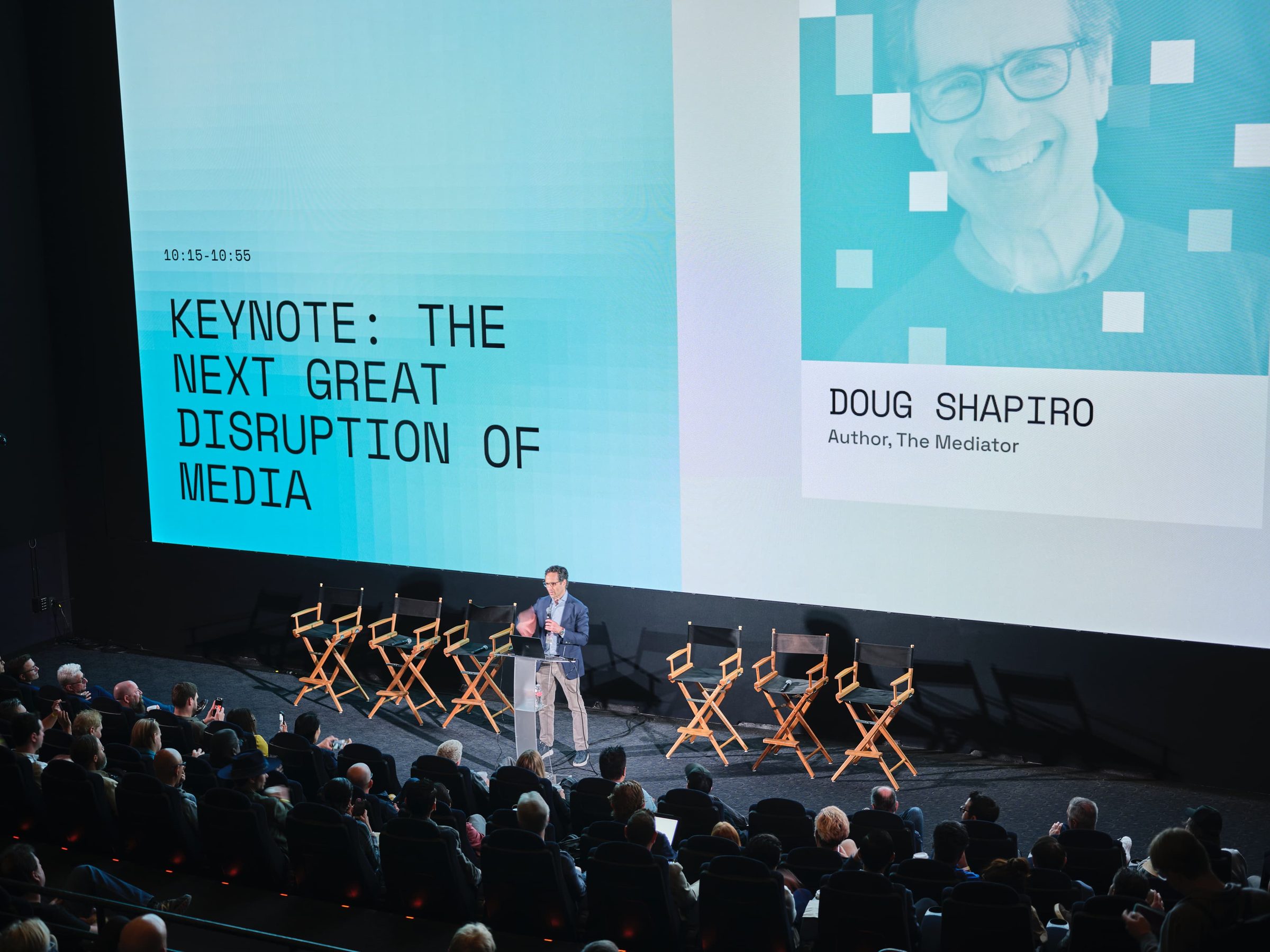 Doug Shapiro on stage beside a screen reading Keynote: The Next Great Disruption of Media.