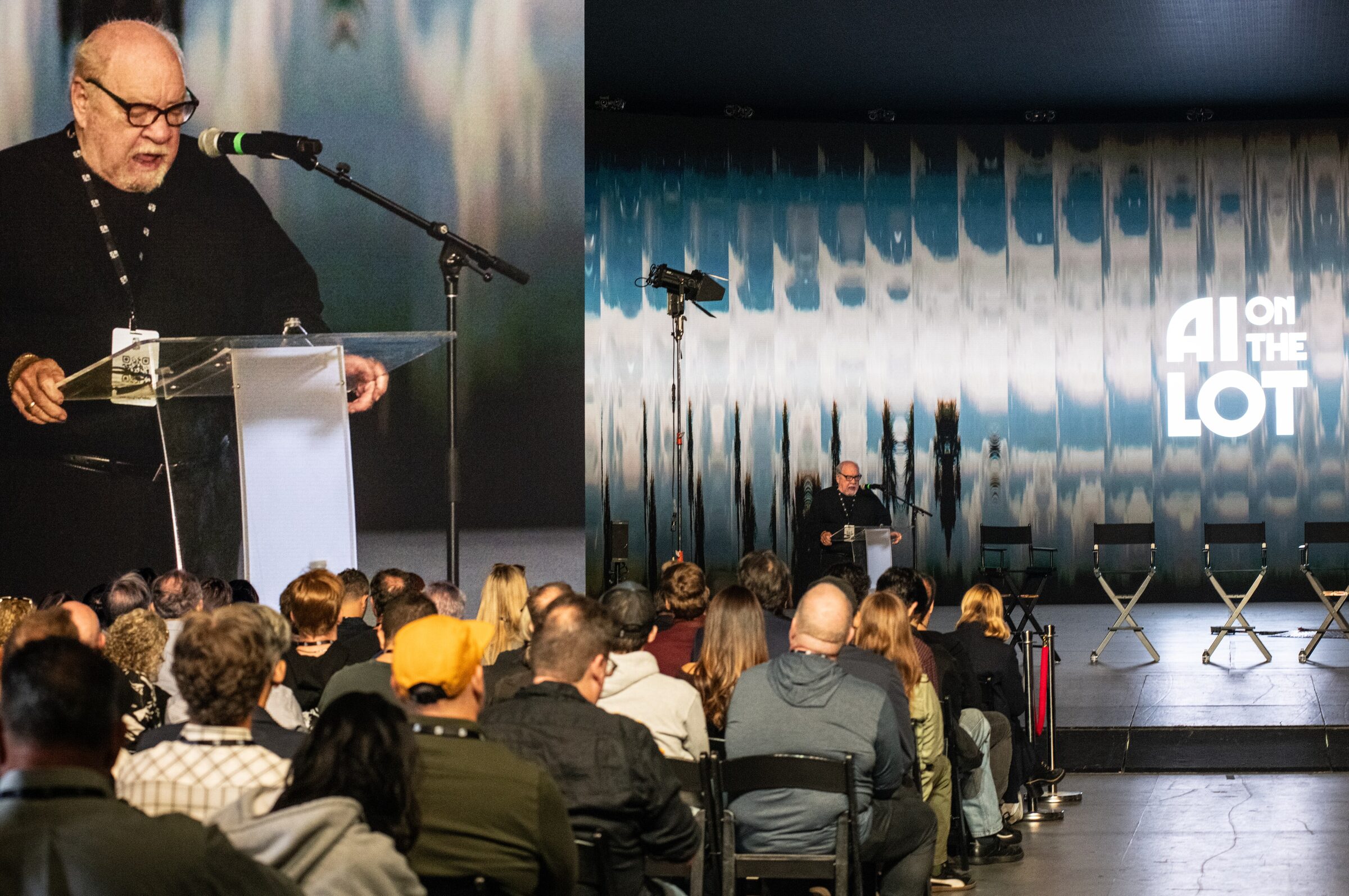 Paul Schrader reads at a lectern, inset in close-up beside a wide shot of him before a seated audience.